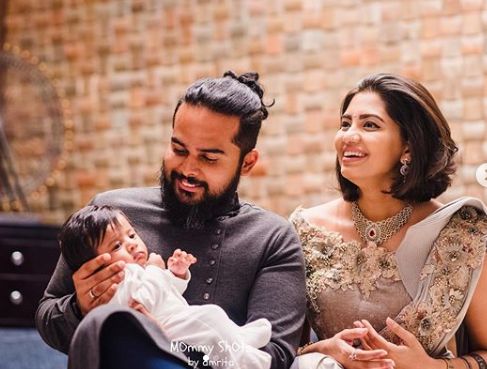 Disha Madan with her husband and child